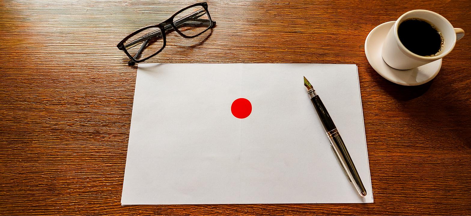 Blank notice paper with a marked red circle beside reading glasses and a fountain pen. Tax appeals tribunal Kenya.