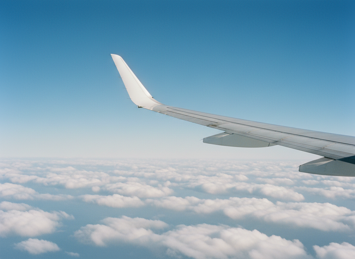 Aircraft wing against a bright blue sky illustrating aviation law in Kenya